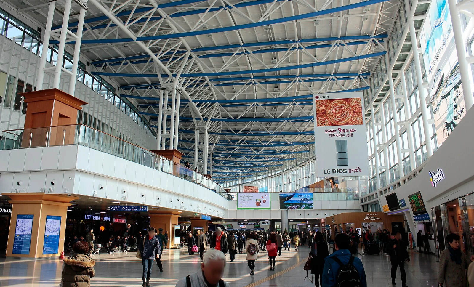 Wide main concourse inside Seoul Station with information screens and passenger routes